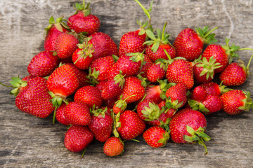 Ripe fresh strawberries on rustic wooden background. Top view