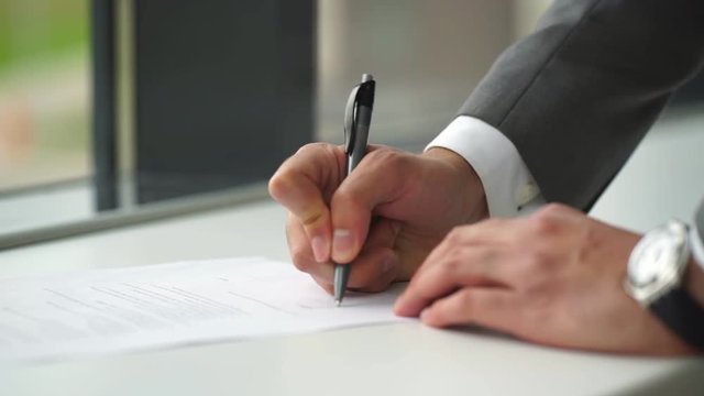 Close up business man signing contract making a deal, classic business