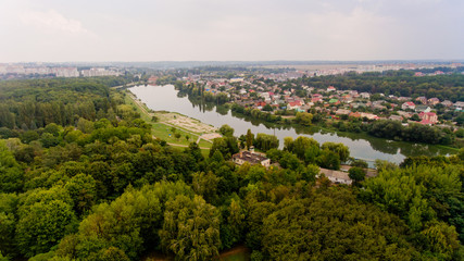 Arial view of a beautiful landscape of a park, a city and a lake.
