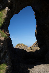 Unique rock formation, cave and blue sky, Antrim coast, North Ireland