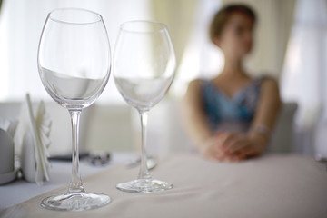 glasses on the table serving restaurant light background girl