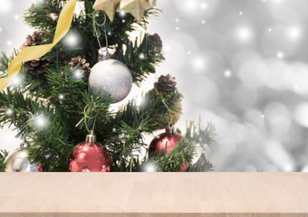 wood table with christmas tree decorations and snowflake on bokeh background. for Happy New Year 2018