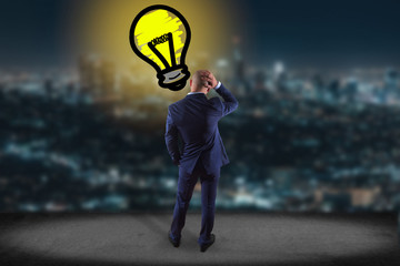 Businessman in front of a wall with Innovation bulb lamp turned on -Inspiration concept