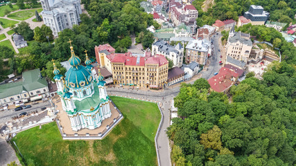 Aerial top view of Saint Andrew's church and Andreevska street from above, cityscape of Podol...