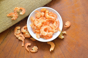 Fototapeta na wymiar dry salted shrimp in cup on wooden table