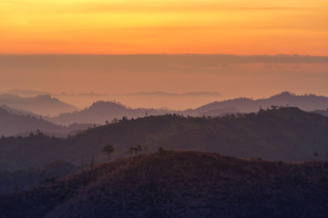 high view sunrise in early morning over  rainforest with  layer mountain in thailand 