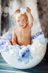 Little boy sits in a white toy egg
