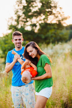 Parents hold their son tightly standing on the field