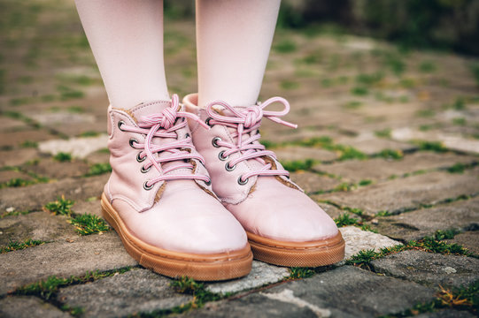 Fashion pink shoes on kid's feet