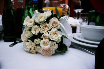 Beautiful bouquet of white roses on an table 