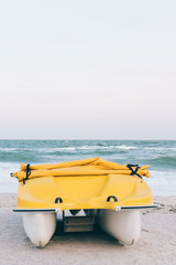 Yellow plastic boat on the beach