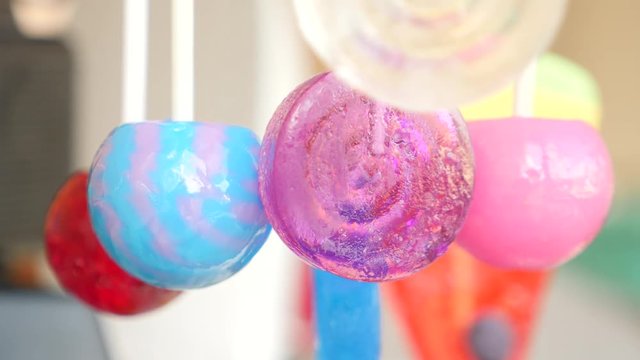 colorful lollipops hang in the air. 4k slow motion