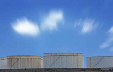 Fototapeta premium oil storage tanks with blue sky and clouds