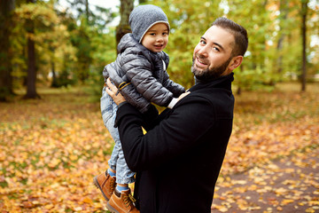 Fototapeta premium father with son in autumn park