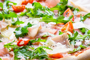 Fototapeta na wymiar Italian prosciutto and rucola pizza.