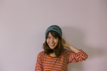 A fashion portrait of young hipster asian woman wearing sweater and beanie knit hat