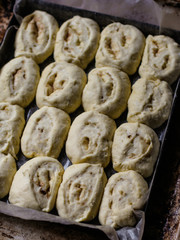 baking rolls with cinnamon - raw dough on a baking tray