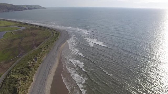 A High Aerial Shot Looking Down on the Sea and Stony Beach
