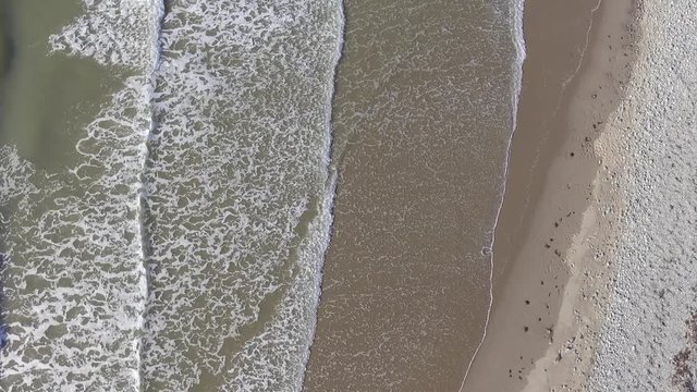 A Short Ascending Aerial Shot of Waves at Fairbourne Beach