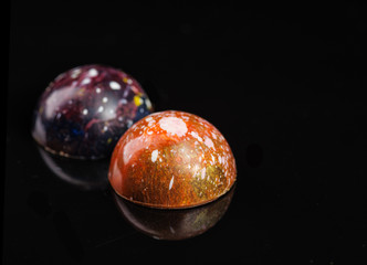 Close-up delicious chocolate pralines on dark background