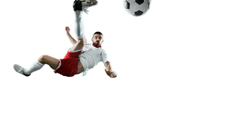 Soccer player performs an action play and beats the ball. Isolated football player in unbranded sport uniform on a white background. © Alex