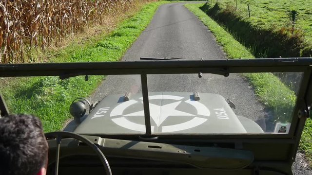 military 4x4 car driving on the small road