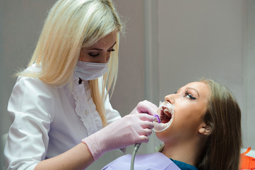 female dentist treating patient