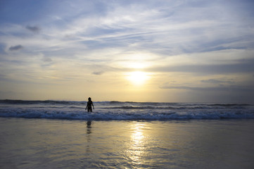 Fototapeta premium young active woman on sea landscape sunset horizon with amazing sun and dramatic orange sky