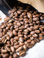brown craft paper bag with roasted coffee beans