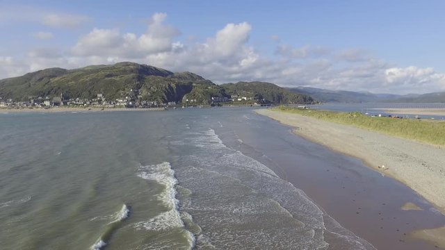 Slow Moving Aerial Shot Flying of the Waves at Fairbourne Beach