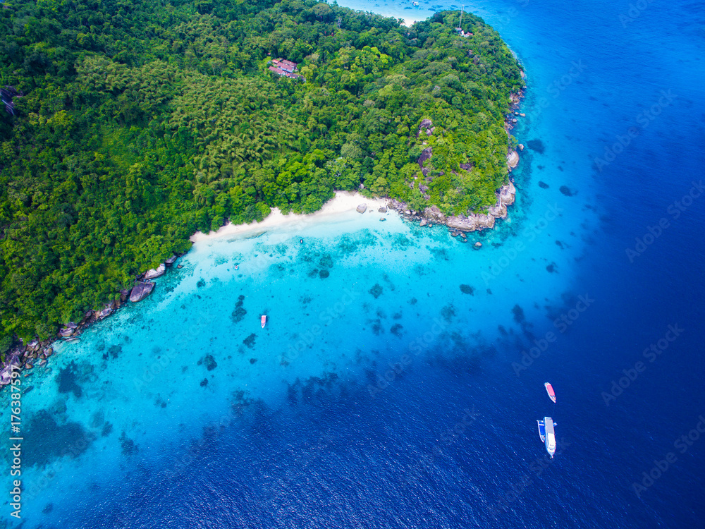 Wall mural top aerial view of isolated beautiful tropical island with white sand beach, blue clear water and gr