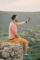 Young man smiling and enjoying sunny summer day