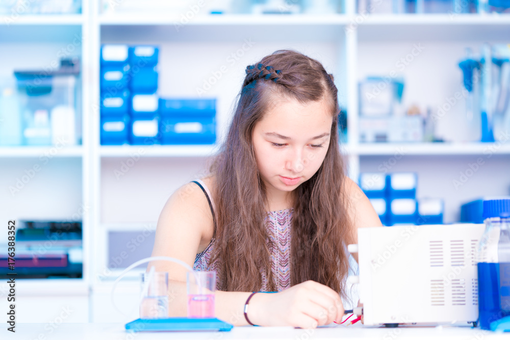 Wall mural schoolgirl is experimenting with a hydrogen fuel cell