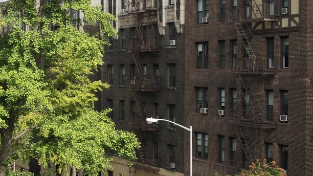 A daytime high angle exterior establishing shot (DX) of typical brick apartment buildings in Manhattan.  	