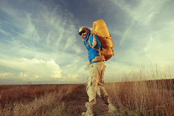 man traveler with a backpack wildlife adventure