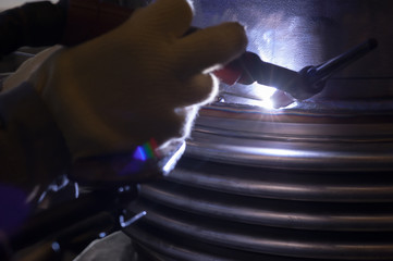 Welder with protective mask welding metal and sparks