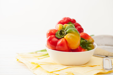 Sweet colorful raw peppers, green onions in the kitchen