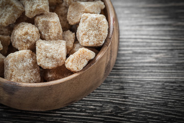 Brown sugar in round bowl on vintage wood board