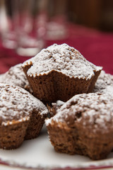 cake with raisins at the plate, sprinkled with powdered sugar