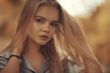 Fototapeta premium Young girl in autumn portrait, blond adult