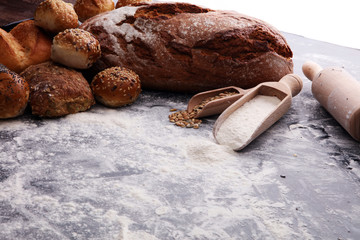 Different kinds of bread and bread rolls on black board. Kitchen or bakery poster design