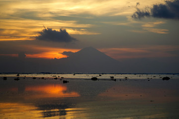Beautiful sunset over the ocean with view of volcano mountain © triocean