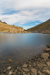 Night landscape of a high mountain lake under moonlight