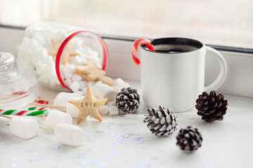 Fototapeta na wymiar Winter cozy background with Marshmallow, ginger bread, Cup of coffee.Cozy sweet Christmas background