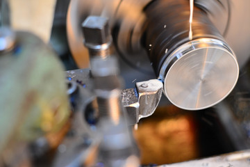 Professional machinist. Horizontal shot of a man operating lathe grinding machine metalworking industry concept copyspace