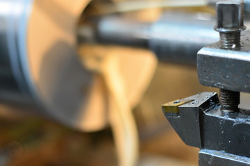 Professional machinist. Horizontal shot of a man operating lathe grinding machine metalworking industry concept copyspace
