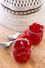 red jelly, cut into dice, inside two glasses of glass
