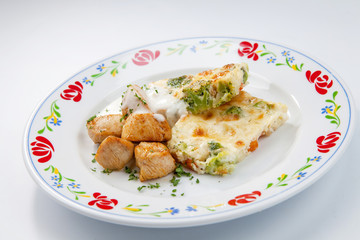 simple dish of Russian, Belarusian, Ukrainian cuisine on a white background Cutlets with potatoes and pickled cucumbers..