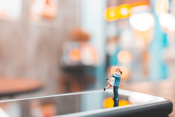 Miniature people , Couple standing on smartphone , love concept