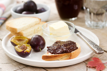 Toasts with plum chocolate jam. Breakfast in the garden. Rustic style, selective focus.